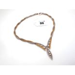 A 1960's 18ct Two Colour Gold Diamond Set Necklace, of textured twisted design, shaped to the