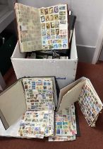 World stamps haphazardly mounted in twenty albums, includes some duplication.
