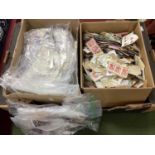 Two Boxes of World Stamps; One box containing 'on paper' stamps, and a box containing 'off paper'
