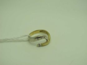 A Modern Two Colour Dress Ring, inset and claw set, stamped "585" (finger size P½) (3.5 grams).