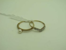 A Modern Dainty Pearl Dress Ring, between claw set shoulders, stamped "375" (finger size L1/2);