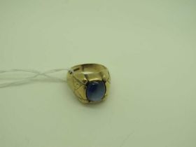A 9ct Gold Cabochon Sapphire Single Stone Ring, inset between wide tapering shoulders, with engraved