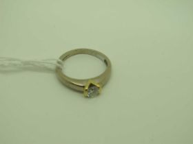 A Modern 18ct Yellow and White Gold Single Stone Diamond Ring, the brilliant cut stone semi