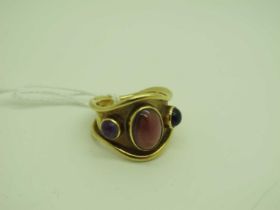 A Byzantine Style Amethyst and Garnet Three Stone Ring, oval and circular cabochon set, within