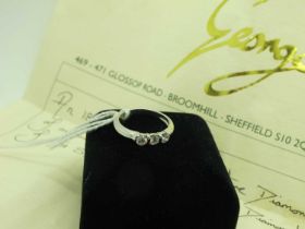 A Modern Three Stone Diamond Ring, the brilliant cut stones rubover set (indistinctly stamped) (