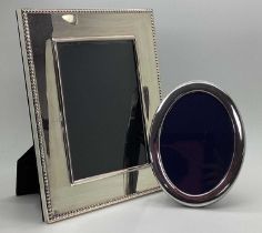 A Hallmarked Silver Mounted Oval Photograph Frame, on plush easel back (16.5cm high); together