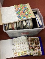 World stamps haphazardly mounted in eighteen albums, includes some duplication.