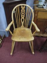Treske, Thirsk North Yorks Ash Elm Wheel Back Rocking Chair, with a hooped back, pierced splat on