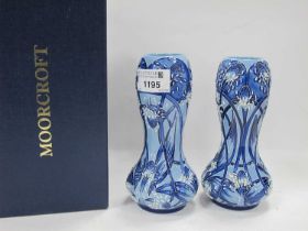 Moorcroft Pottery, a pair of bulbous vases in the Macintyre manner with stylized flowers in shades