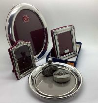 A Pewter Mounted Oval Photograph Frame, on plush easel back, overall height 22cm; together with