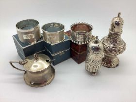 Three Hallmarked Silver Napkin Rings, boxed; together with two hallmarked silver pepperettes and a