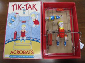 A late 20th Century tinplate wind up Tik-Tak Acrobats toy by Schylling, boxed.
