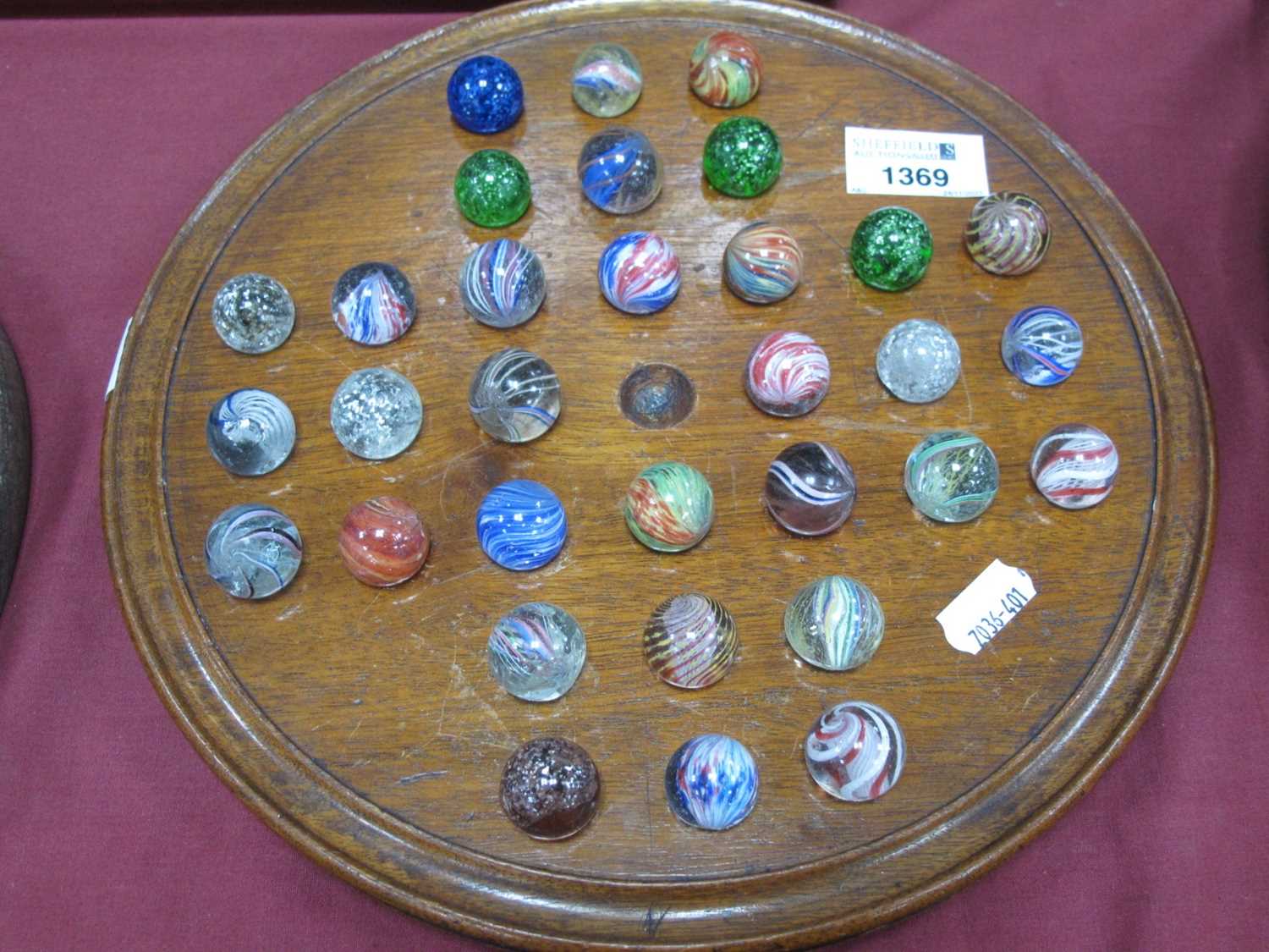 A solitaire board complete with Victorian marbles (32) dimensions board 27cm and all marbles about