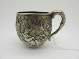 A Chinese Cup, allover detailed in relief with battle scene, bamboo style handle, stamped