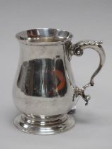 A Victorian Hallmarked Silver Mug, GA, London 1882, of plain baluster form, with leaf capped