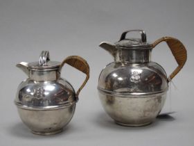 An Art Deco Style Globular Tea Pot and Matching Hot Water Pot, each detailed in relief with