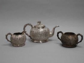 A Chinese Three Piece Tea Set, each allover detailed in relief with bamboo (indistinctly stamped