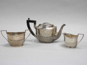 Gorham; An American Three Piece Bachelors Tea Set, of oval semi reeded form, initialled (teapot
