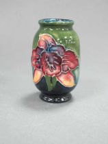 A Moorcroft Pottery Miniature Vase, of ovoid form, painted with the 'Bearded Iris' pattern on a