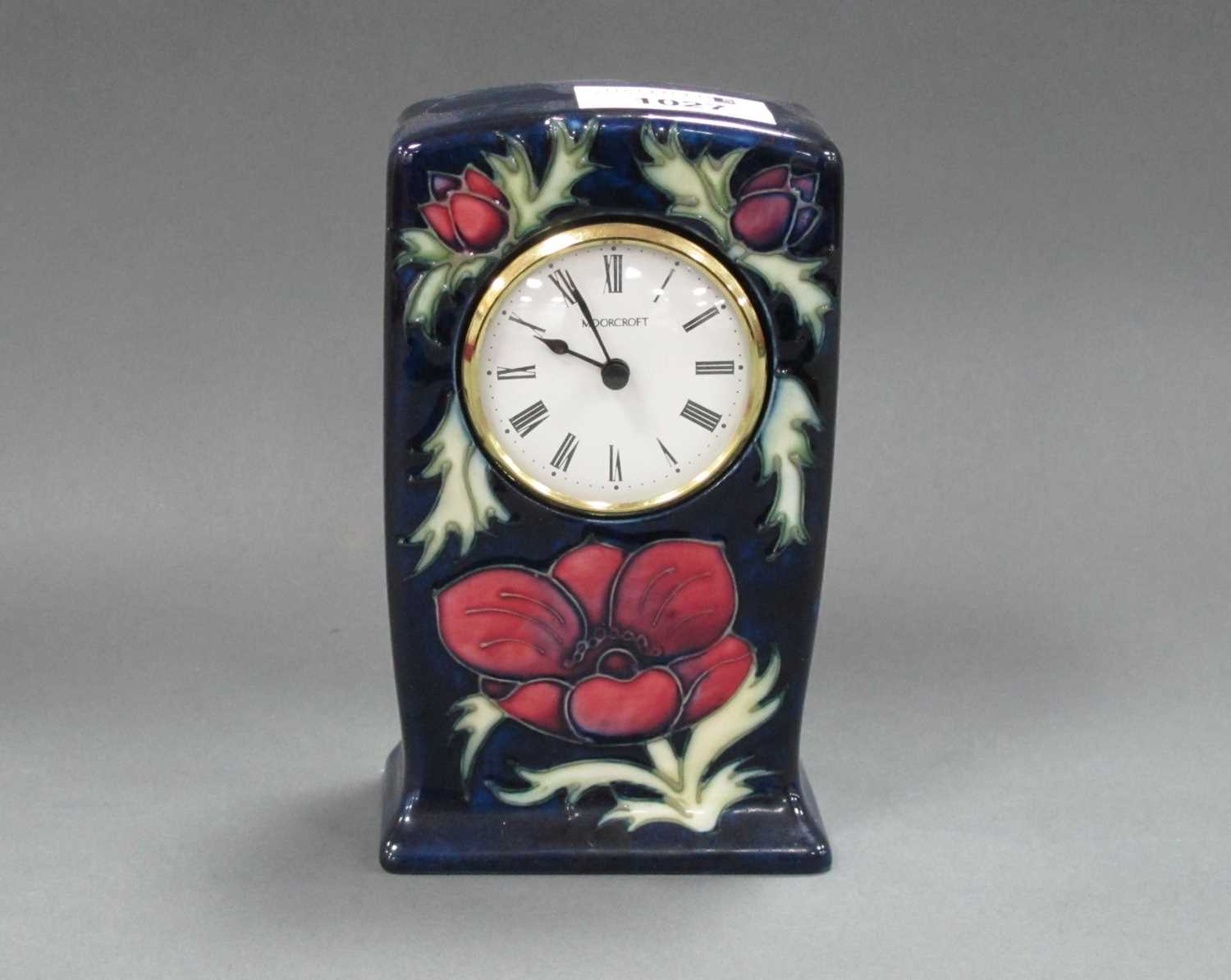 A Moorcroft Pottery Mantle Clock, painted in the 'Anemone' pattern, 15.5cm high. some pitting to