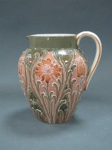 A Moorcroft Macintyre Pottery Jug, circa 1920's, with stylised sprouting and bud flowers within