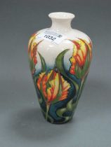 A Moorcroft Pottery Bud Vase, decorated with a design of green trailing leaves in the Art Nouveau