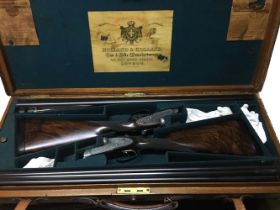 PAIR NUMBERED HOLLAND AND HOLLAND SHOTGUNS