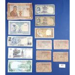 A wad of world banknotes including 12 total examples: Laos: circa 1960 Kip: 1, 10, 20 & 100 Thailand