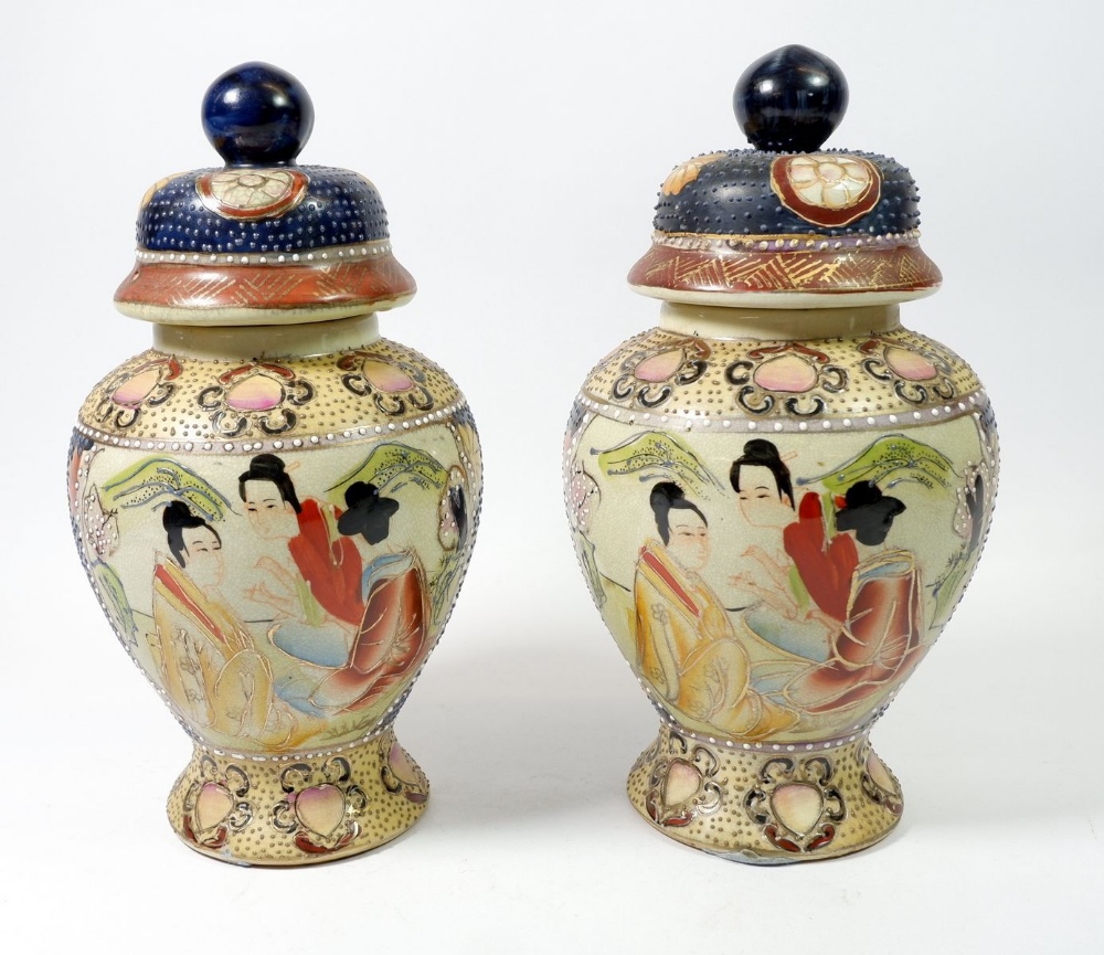 A pair of Japanese Meji period baluster form vases and covers painted seated figures, 27cm