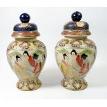A pair of Japanese Meji period baluster form vases and covers painted seated figures, 27cm