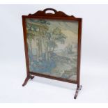 A mahogany framed large tapestry firescreen