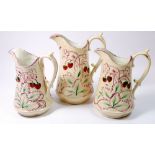 A Victorian set of three jugs moulded and painted strawberries