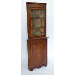 An Edwardian mahogany corner display cabinet with marquetry decoration to cupboard