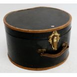 A leather bound hat box with fabric interior