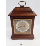 A Garrard Elliott walnut mantel clock, 21cm tall