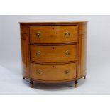 A George III satinwood and ebony inlaid demi-lune commode chest of three drawers flanked by dummy