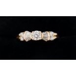 An 18 carat gold ring set brilliant cut diamond flanked by baguette cut diamonds and four smaller