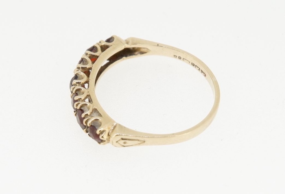 A 9 carat gold ring set seven garnets, size O - Image 4 of 5