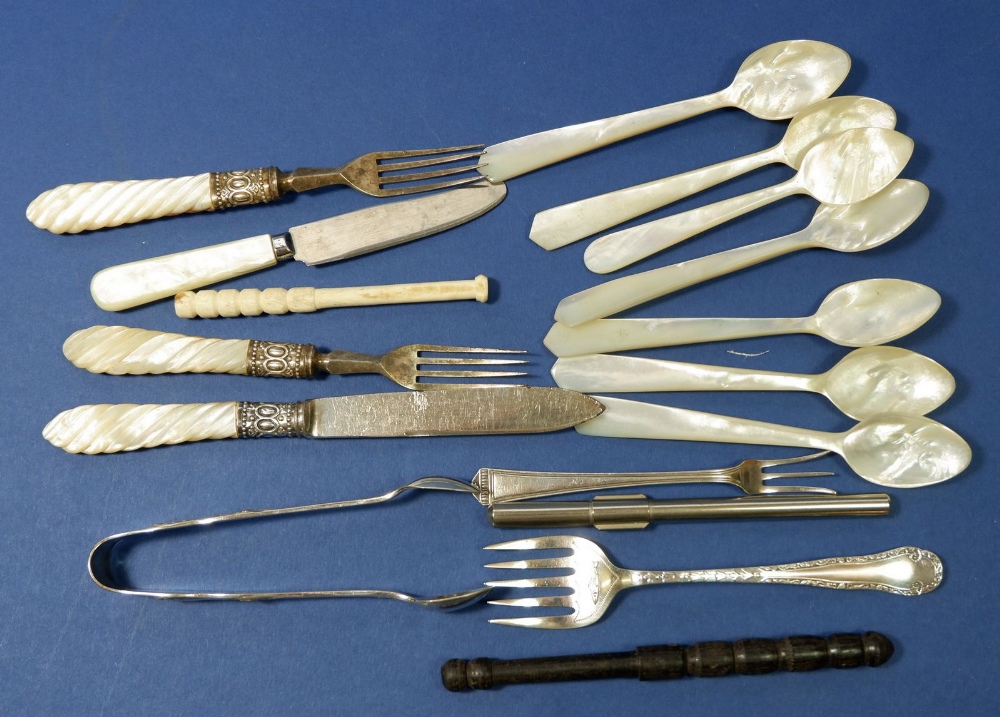 A group of silver and mother of pearl cutlery including seven mother of pearl spoons