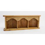A pine arcaded wall shelf with three arched compartments, 106cm wide x 39cm high