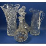 A pair of facet cut glass bottle form decanters, a large cut glass jug and vase