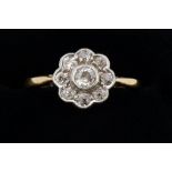 An 18 carat gold and platinum set diamond cluster ring, size N