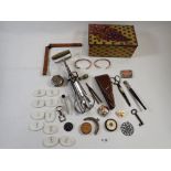 A tin of collectables including scissor case, tape measure etc.