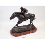 A bronze finish jockey and horse group, 23cm tall