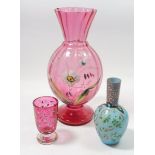 A Victorian cranberry glass vase painted flowers, 26cm and two small enamelled glass vases