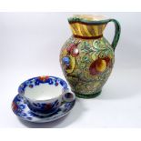 A Majolica style pottery jug and a large breakfast cup and saucer