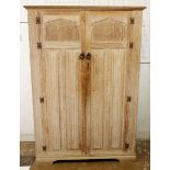 A Crown Ay limed oak two door carved wardrobe