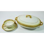 A Limoges C Ahrenfeldt gilt and white dinner service comprising:- seven dinner plates, seven side