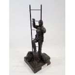 A bronze finish figure of a workman and ladder, possibly a sailor, 32cm tall