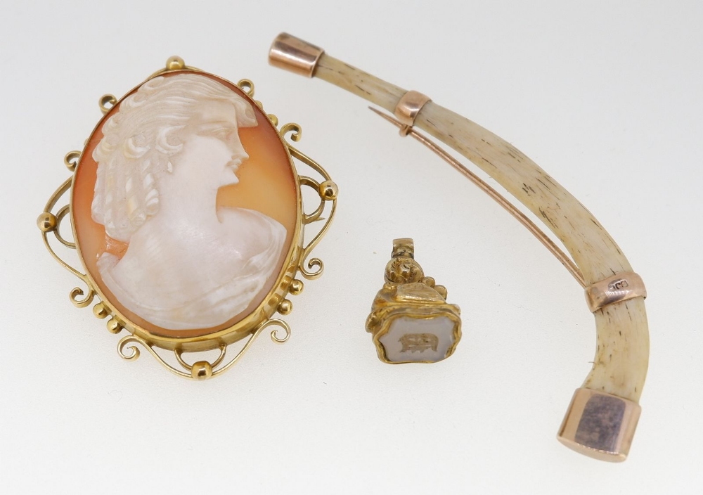 A 9 carat gold mounted cameo brooch, 5 x 4cm, a gold mounted bone and a yellow metal seal